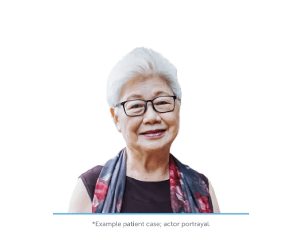 Smiling woman with dark hair holding a medical device for tumor treating fields, representing innovative cancer treatment.