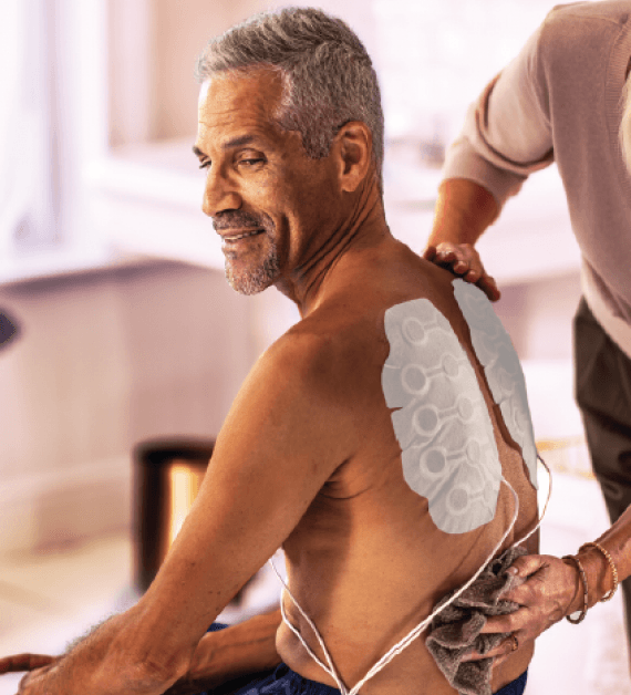 Medical professional using a patient-focused digital device designed to fit seamlessly into healthcare settings